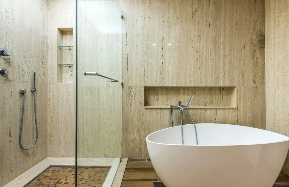 Sleek minimalist bathroom featuring a freestanding bathtub and glass shower with contemporary design.